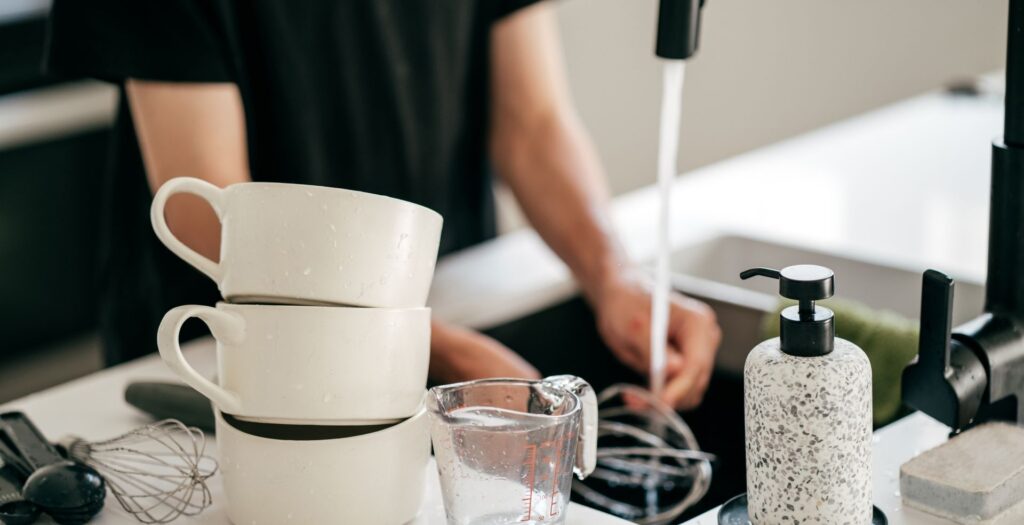 Professional cleaner from Level Up Cleaning Tulsa tidying a modern kitchen in a Tulsa home